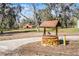 Rustic stone well feature with barn in the background on a sunny day at 10944 Autumn Ln, Clermont, FL 34711