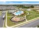 Community aerial view showcasing a resort-style pool and playground, surrounded by lush greenery at 11090 Silver Surfer Aly, Winter Garden, FL 34787