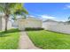 Manicured backyard with healthy lawn, sidewalk, and well-maintained fence at 11090 Silver Surfer Aly, Winter Garden, FL 34787