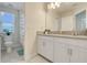 Bathroom features dual sink vanity, with bright window to the left of the toilet and shower at 11090 Silver Surfer Aly, Winter Garden, FL 34787