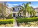 Inviting two-story home with a lovely front porch and lush green landscaping at 11090 Silver Surfer Aly, Winter Garden, FL 34787