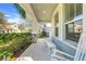 Inviting covered front porch with cozy rocking chairs, creating a welcoming entrance at 11090 Silver Surfer Aly, Winter Garden, FL 34787