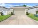 Attached two-car garage with manicured landscaping and a spacious driveway for extra parking at 11090 Silver Surfer Aly, Winter Garden, FL 34787