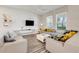 Cozy living room featuring modern furniture, stylish decor, a ceiling fan, and plenty of natural light at 11090 Silver Surfer Aly, Winter Garden, FL 34787