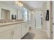 Main bathroom featuring double sinks, a walk-in shower with glass door, and tile flooring at 11090 Silver Surfer Aly, Winter Garden, FL 34787