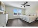 Bedroom featuring hardwood flooring, a ceiling fan, and a large bed with white bedding at 11090 Silver Surfer Aly, Winter Garden, FL 34787