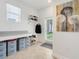 Well-organized mudroom with storage bins, shelving, and access to the outdoors at 11090 Silver Surfer Aly, Winter Garden, FL 34787