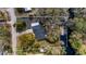 Aerial view of property showcasing its waterfront location, mature trees, and proximity to the lake at 11136 Bronson Rd, Clermont, FL 34711