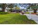 Inviting backyard with patio area, mature trees, and manicured lawn ideal for outdoor gatherings and relaxation at 11136 Bronson Rd, Clermont, FL 34711