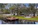 Scenic backyard view features a pond with a dock, gazebo, and well-maintained lawn at 11136 Bronson Rd, Clermont, FL 34711