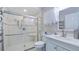 Modern bathroom with a glass-enclosed shower and sleek fixtures, plus a white vanity at 11136 Bronson Rd, Clermont, FL 34711