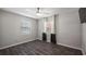 Neutral bedroom featuring updated floors and two double-hung windows for natural light at 11136 Bronson Rd, Clermont, FL 34711