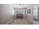 Bright dining room featuring updated floors and a decorative accent cabinet at 11136 Bronson Rd, Clermont, FL 34711