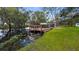 Private dock with covered boat lift and seating, providing direct access to the tranquil lake at 11136 Bronson Rd, Clermont, FL 34711