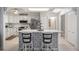 Bright kitchen featuring a center island with decorative tiles, stainless steel appliances and white cabinets at 11136 Bronson Rd, Clermont, FL 34711