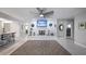 Bright and airy living room with a white fireplace, modern decor, and tile flooring at 11136 Bronson Rd, Clermont, FL 34711