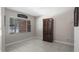 Neutral living room featuring updated tile flooring, modern blinds, and a decorative wall hanging at 11136 Bronson Rd, Clermont, FL 34711