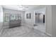 Living room with tile floors, gray accent wall and natural light at 11136 Bronson Rd, Clermont, FL 34711