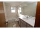 Well-lit bathroom with a combination shower and tub, single sink vanity, and tile flooring at 11740 E Highway 25, Ocklawaha, FL 32179