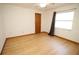 Bedroom with wood floor, a ceiling fan, and a window with curtains at 11740 E Highway 25, Ocklawaha, FL 32179