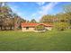 Charming single-story home featuring a vibrant red roof and a well-manicured lawn at 11740 E Highway 25, Ocklawaha, FL 32179