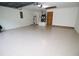 Spacious garage with epoxy flooring, ample storage, and access doors, perfect for multiple vehicles at 11740 E Highway 25, Ocklawaha, FL 32179