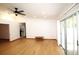 Living room with high ceiling, wood floor, and sliding glass door at 11740 E Highway 25, Ocklawaha, FL 32179