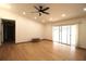 Bright living room featuring hardwood floors, a ceiling fan, recessed lighting, and sliding glass doors at 11740 E Highway 25, Ocklawaha, FL 32179