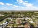 Aerial view of a residential neighborhood featuring tree-lined streets and various homes at 12320 Blue Heron Way, Leesburg, FL 34788