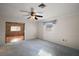 Spacious bedroom featuring neutral walls, plush blue carpeting, and a ceiling fan for comfort at 12320 Blue Heron Way, Leesburg, FL 34788