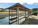 Covered boat dock with water access, ideal for boating and waterfront enjoyment at 12320 Blue Heron Way, Leesburg, FL 34788