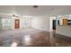 Bright living room with a stone accent wall and access to the kitchen at 12320 Blue Heron Way, Leesburg, FL 34788