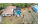 Aerial view of a pool, the back of the house, and the fenced backyard at 1236 Selman Rd, Leesburg, FL 34748