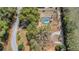 An aerial view of the home with the screened in pool, surrounded by mature trees at 1236 Selman Rd, Leesburg, FL 34748