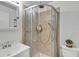 This is a bathroom with beige tile in the shower and modern fixtures, including a glass shower door at 1236 Selman Rd, Leesburg, FL 34748