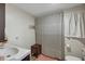 Bright bathroom featuring a vanity, a wooden storage bench, a toilet and a shower with a curtain at 1236 Selman Rd, Leesburg, FL 34748