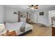 Comfortable bedroom featuring light-colored walls and wood floors, with a cozy chair by the window at 1236 Selman Rd, Leesburg, FL 34748