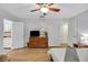 Bright bedroom featuring wood floors, a television on a dresser, and access to the bathroom at 1236 Selman Rd, Leesburg, FL 34748