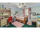 Cozy bedroom featuring a bed, a desk, a decorative rug, and unique decor at 1236 Selman Rd, Leesburg, FL 34748