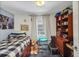 Well-lit bedroom with a checkered bedspread, natural lighting, and a playful teddy bear accent at 1236 Selman Rd, Leesburg, FL 34748