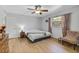 Bright bedroom with hardwood floors, ceiling fan, and natural light from a window at 1236 Selman Rd, Leesburg, FL 34748