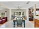 Spacious dining room featuring a wooden table, blue chairs, and a large window with plenty of natural light at 1236 Selman Rd, Leesburg, FL 34748