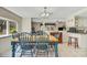 Dining area featuring a wooden table, blue chairs, and a large window, perfect for Gathering meals and entertaining at 1236 Selman Rd, Leesburg, FL 34748