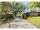 Long driveway to home with mature trees and gate at 1236 Selman Rd, Leesburg, FL 34748