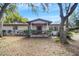 Charming single-story home featuring a cozy front porch and mature trees at 1236 Selman Rd, Leesburg, FL 34748