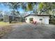 Rear exterior view of the home featuring a screened in pool area, patio and a detached structure at 1236 Selman Rd, Leesburg, FL 34748