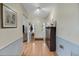 Hallway with wood-look floors, shoe rack, and access to other rooms at 1236 Selman Rd, Leesburg, FL 34748