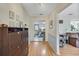 Hallway with wood-look floors and view into the kitchen and living room at 1236 Selman Rd, Leesburg, FL 34748