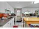 Well-equipped kitchen featuring stainless appliances, tile backsplash, ample counter space, and white cabinets at 1236 Selman Rd, Leesburg, FL 34748