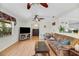 Cozy living room with wood-look floors and view into the kitchen at 1236 Selman Rd, Leesburg, FL 34748